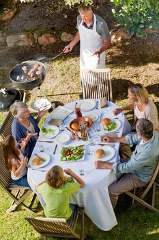 Lovely family eating in the garden