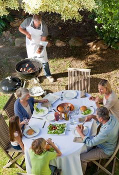 Lovely family eating in the garden