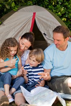 Adorable family camping in the garden