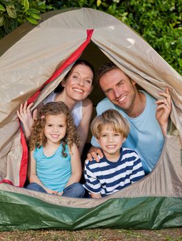 Joyful family camping in the garden