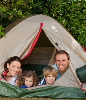 Joyful family camping in the garden