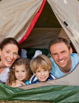 Joyful family camping in the garden