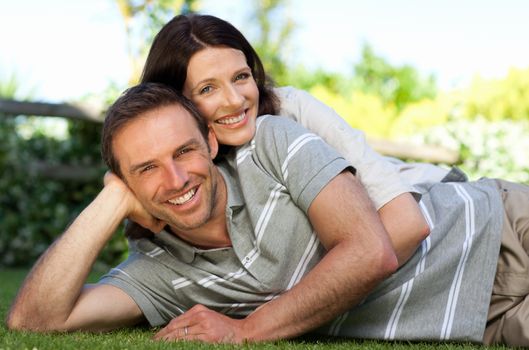 Couple lying down in the garden