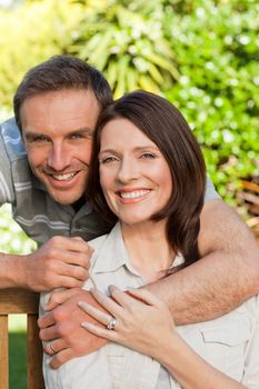 Joyful couple hugging in the garden