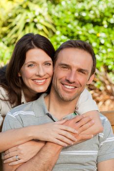 Glad couple hugging in the garden