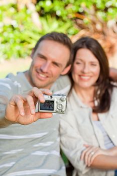 Lovers taking a photo of themselves in the garden