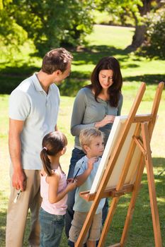 Family painting together in the park