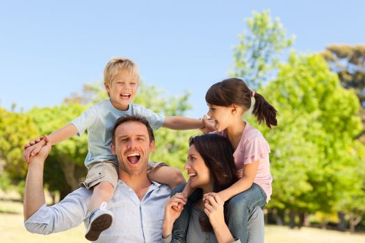 Parents giving children a piggyback 