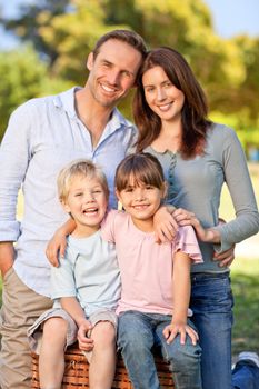 Smiling family picnicking in the park