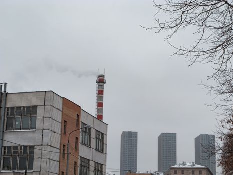 White smoke from an old factory chimney against the sky. Ecology. The concept of the environmental problem of air pollution. Copy space for text.