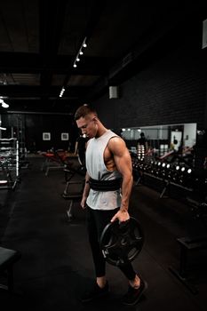 Young fit muscular man with big sweaty muscles doing cross workout training. This image was taken on May 2019 at a Gold GYM New Delhi, India.