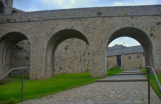 Big stone walls, gate and bridge at Dinan fortress, France