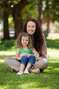 Mother with her daughter sitting in the garden