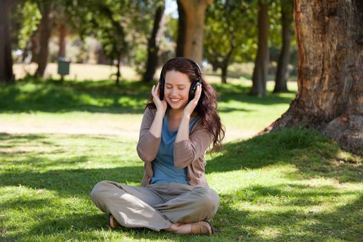 Woman listening to some music in the garden