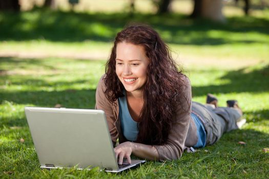 Woman working on her laptop in the park