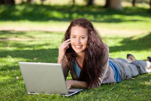 Woman phoning in the park