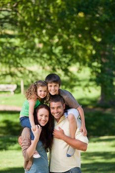 Parents giving children a piggyback