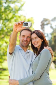 Couple taking a photo of themselves in the park