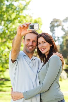 Couple taking a photo of themselves in the park