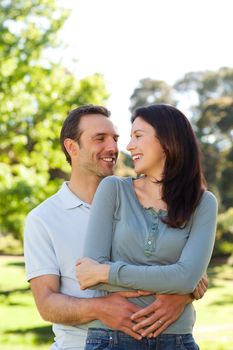 Beautiful couple hugging in the park