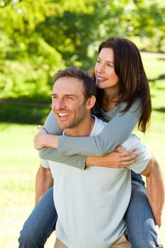 Man giving wife a piggyback