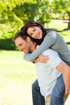 Man giving wife a piggyback