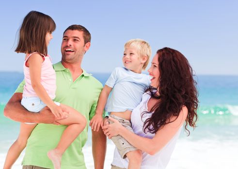 Happy children with their parents at the beach