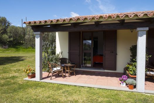 a seat on a terrace of a cottage on the Italian island of Sardinia in summer with blue sky