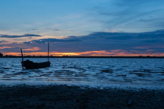 Boat on lake at sunset