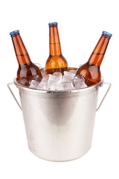 Three brown beer bottles in a bucket of ice isolated on a white background.