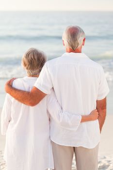 Man hugging his wife on the beach