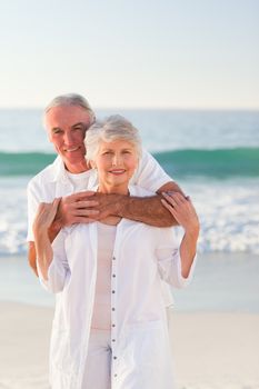 Man hugging his wife on the beach