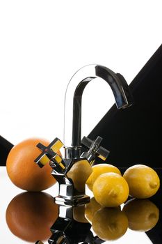 Metal chromium-plated mixer for wwater on a studio background