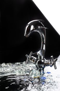 Metal chromium-plated mixer for wwater on a studio background