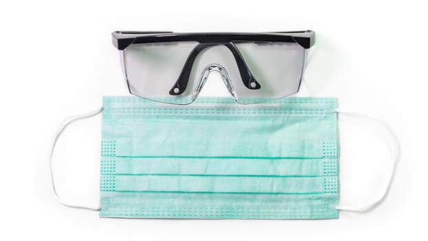 The close up of Anti-viral protection mask and Eye protection glasses on white background.