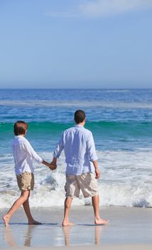 Couple walking on the beach against the sea