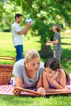 Happy family picnicking in the park during the summer