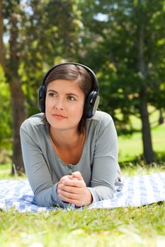 Woman listening to music in the park during the summer