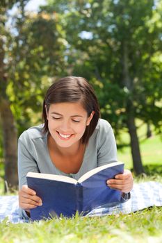 Woman reading a book in the park during the summer