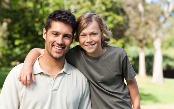 Son and his father in the park during the summer