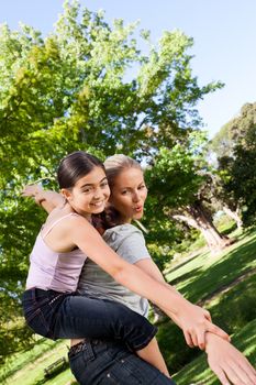 Daughter playing with her mother during the summer