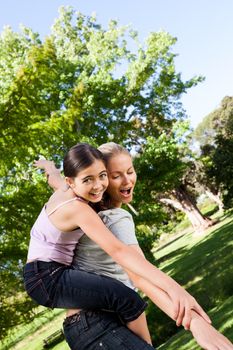 Daughter playing with her mother during the summer