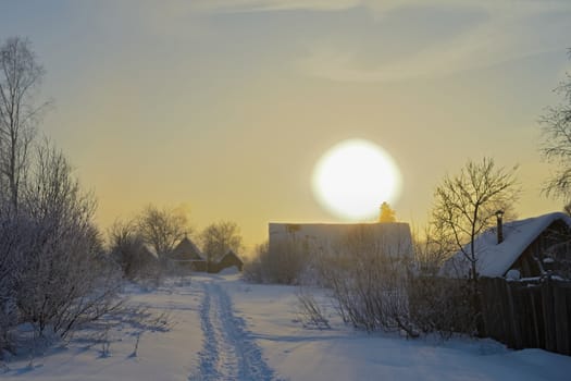 The sun caught on the roof of the house on a winter day.