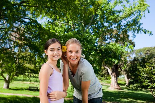 Cute daughter with her mother in the park during the summer