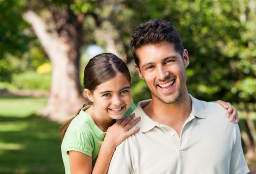 Daughter with her father in the park during the summer