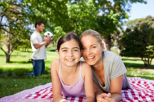 Mother and daughter having fun in the park during the summer