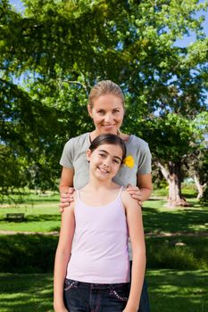 Cute daughter with her mother in the park during the summer