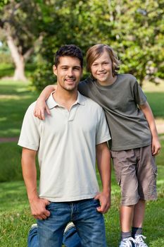 Son and his father in the park during the summer