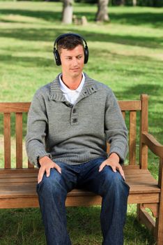 Relaxed man listening to some music during the summer