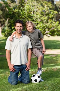 Father and his son in the park during the summer